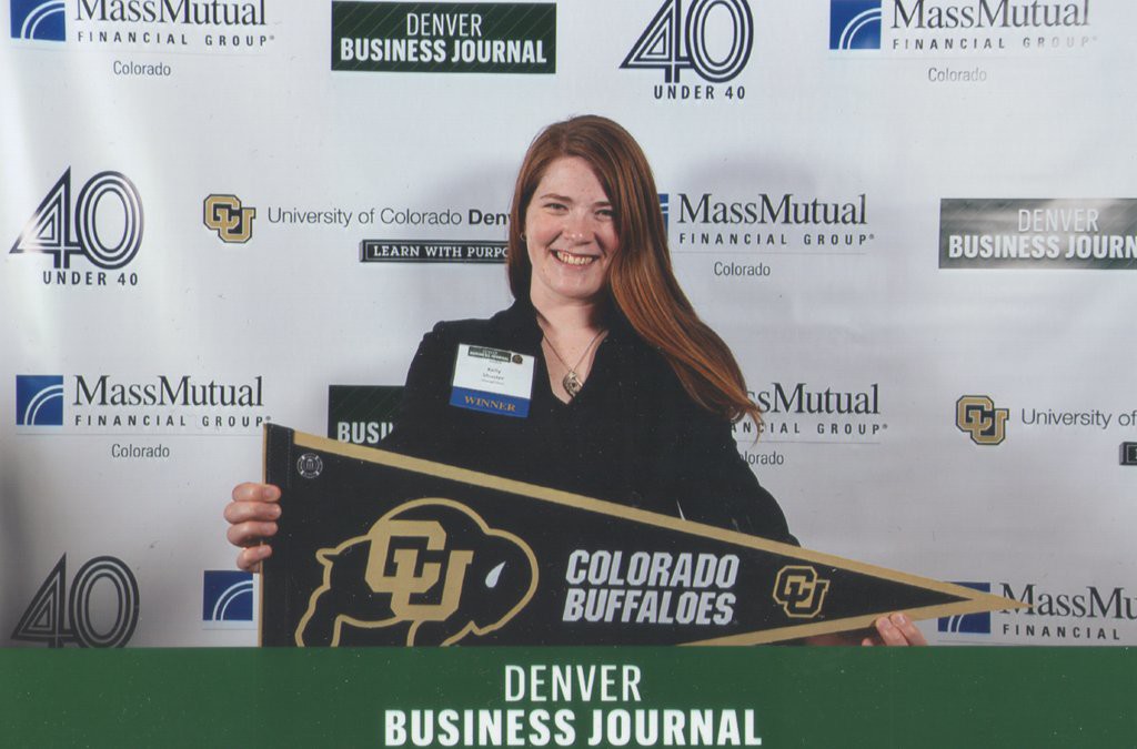 Me holding a CU Buffaloes pennant at the 40 under 40 photo booth