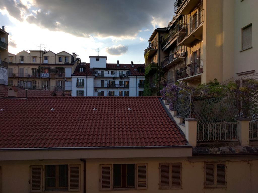 view from the balcony, of other balconies with shutters and plants