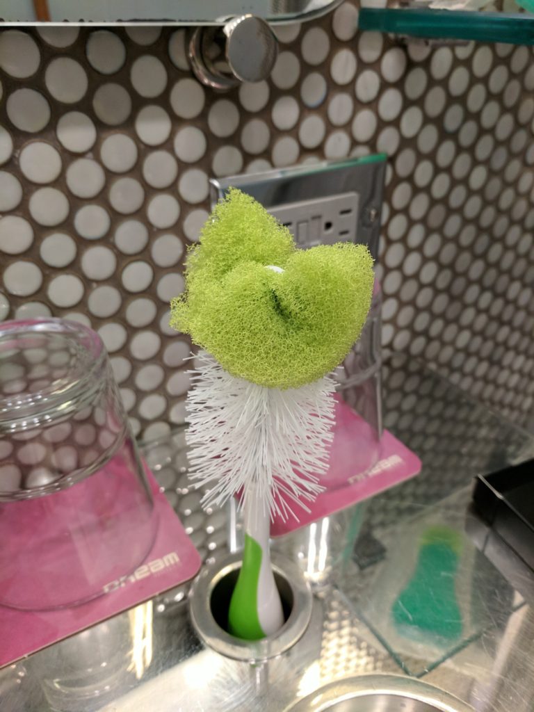 Bottle brush stuck in bathroom toothbrush holder